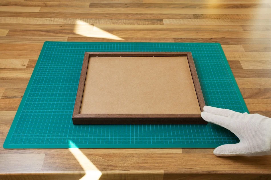 An image of the back of a frame with the print and backing board attached from John Dunne Photography by John Dunne.