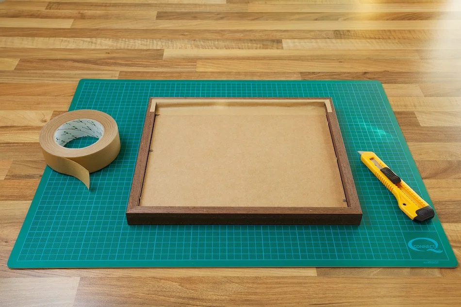 An image showing the backing board and frame being taped down from John Dunne Photography by John Dunne.